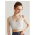 Спортивний кроп топ бюстгальтер на застібках колір слонова кістка топ бра Спортивний кроп топ бюстгальтер на застібках колір слонова кістка топ бра